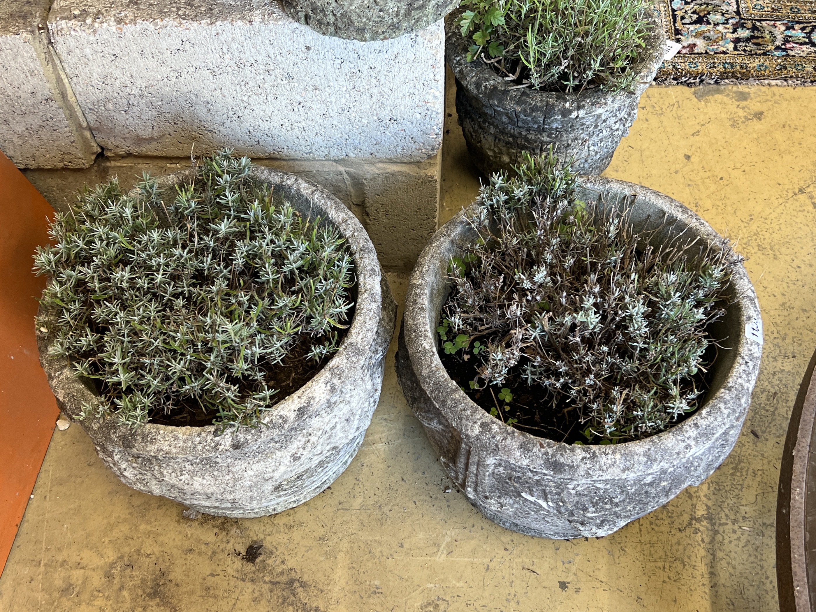 A pair of circular reconstituted stone garden planters, diameter 38cm, height 30cm